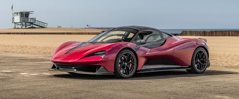 A red sports car on the coast road